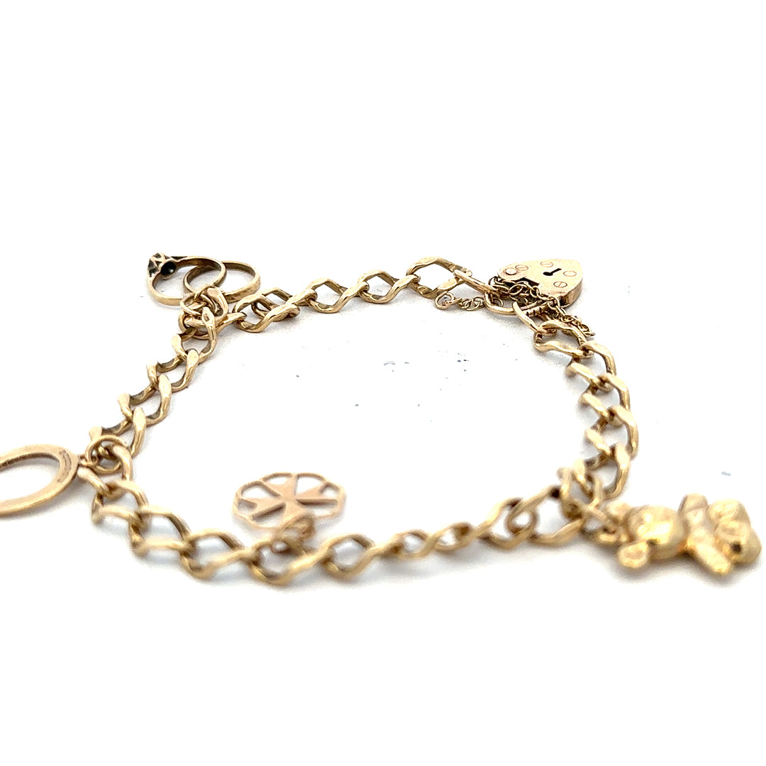 9ct yellow gold charm bracelet with delicate links and charms, weighing 9.9g, unbranded jewelry accessory.