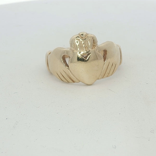 Yellow gold Claddagh ring with detailed design, featuring traditional hands, heart, and crown, unbranded 9ct gold jewelry.
