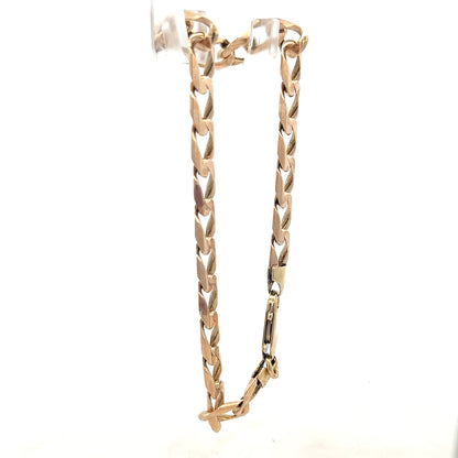 9ct yellow gold curb bracelet weighing 18.3g, unbranded, displayed with detailed chain links and polished finish.