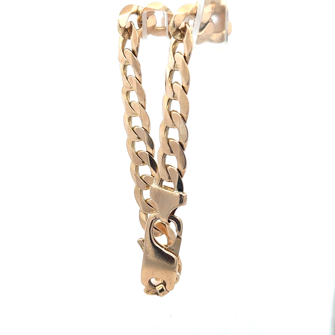9ct yellow gold curb bracelet weighing 31.9g, unbranded, featuring classic interlinked chain design.