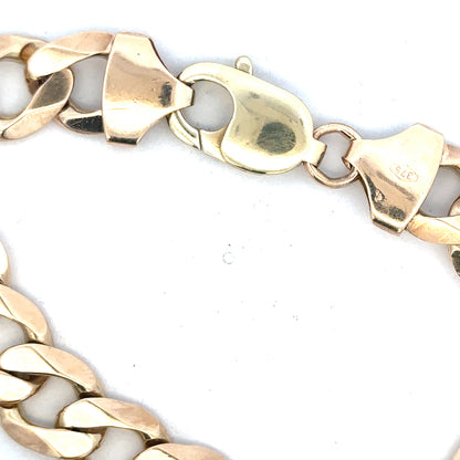 9ct yellow gold curb bracelet with a sturdy chain design, weighs 52.6g, unbranded jewelry piece, close-up view.
