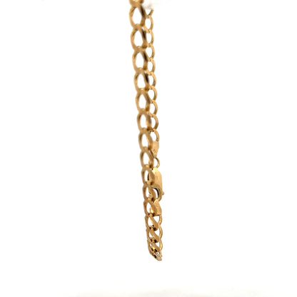Yellow gold curb bracelet with a 7.6g weight, featuring classic linked design, unbranded jewelry accessory.