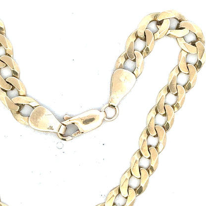 9ct yellow gold curb bracelet weighing 8.3g, unbranded jewelry with classic link design, visible in the image.