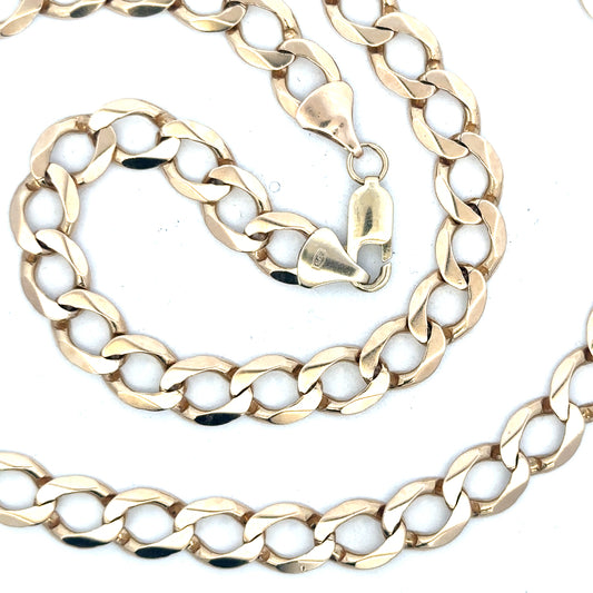 9ct yellow gold curb chain, unbranded, showing the detailed links and polished finish, weighs 53.9 grams.