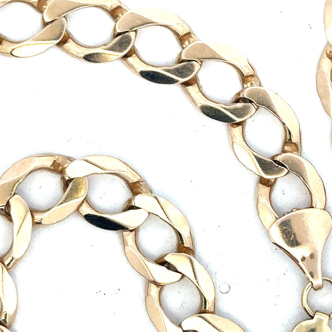 9ct yellow gold curb chain with a polished finish, weighing 53.9 grams, featured in a close-up image.