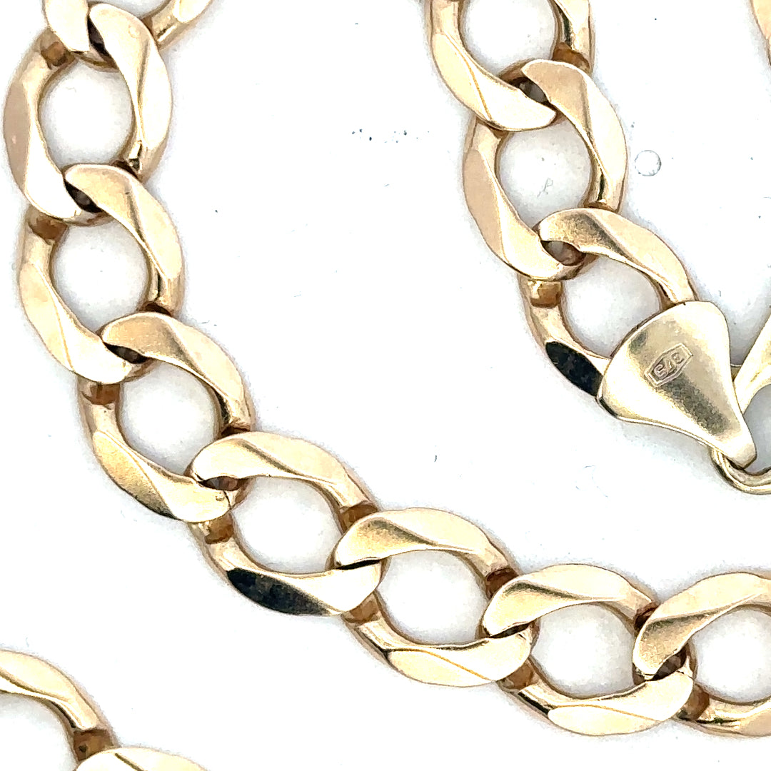 9ct yellow gold curb chain with a sturdy link design, weighing 53.9g, shown in a close-up image.