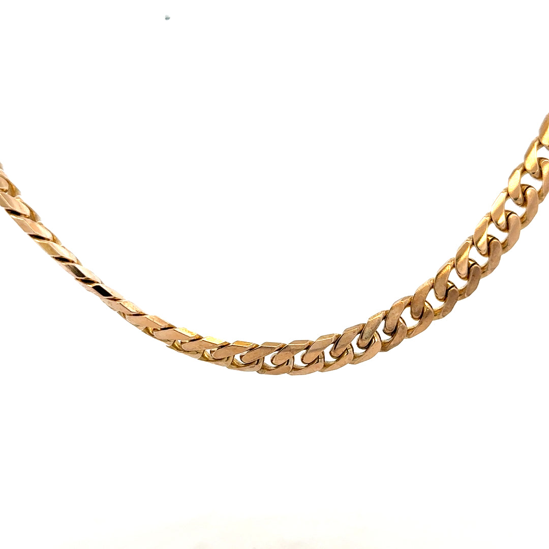 9ct yellow gold curb chain with a sturdy design, weighing 61.4g, showcasing its elegant gold finish and classic chain style.