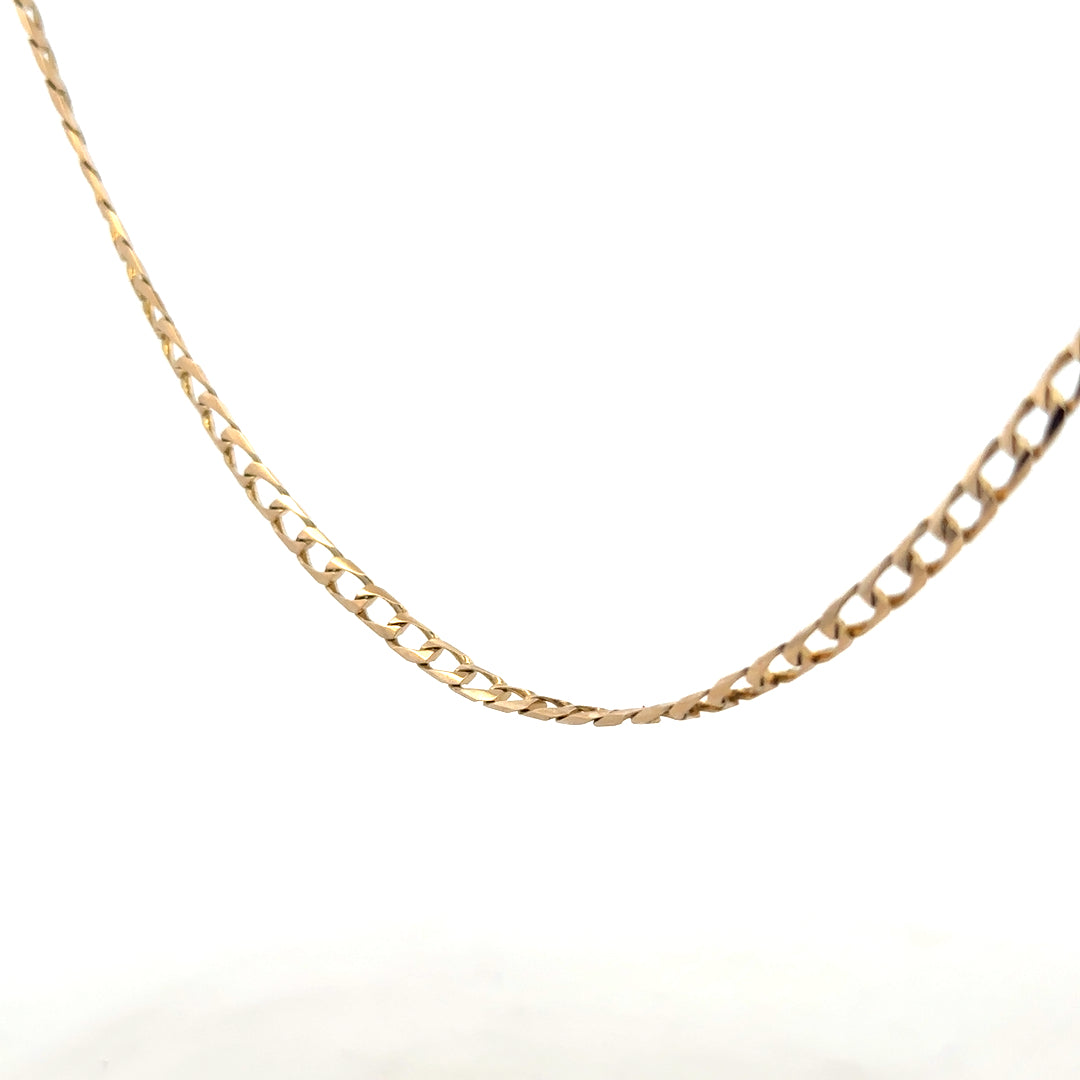 9ct yellow gold curb chain showing its detailed link design and polished finish, weighing 9.9g, unbranded jewelry accessory.