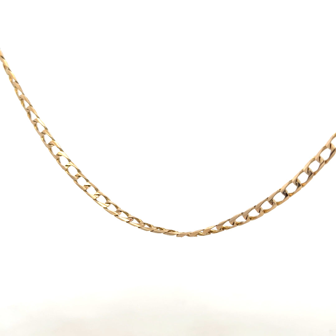 9ct yellow gold curb chain with a 9.9g weight, showcasing a classic gold chain design on a plain background