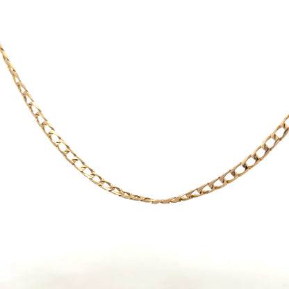 9ct yellow gold curb chain with a 9.9g weight, showcasing a classic gold chain design on a plain background