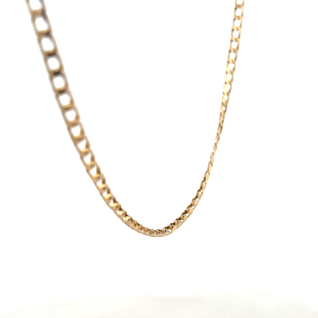 9ct yellow gold curb chain with a polished finish, weighing 9.9 grams, showcasing a classic jewelry chain design.