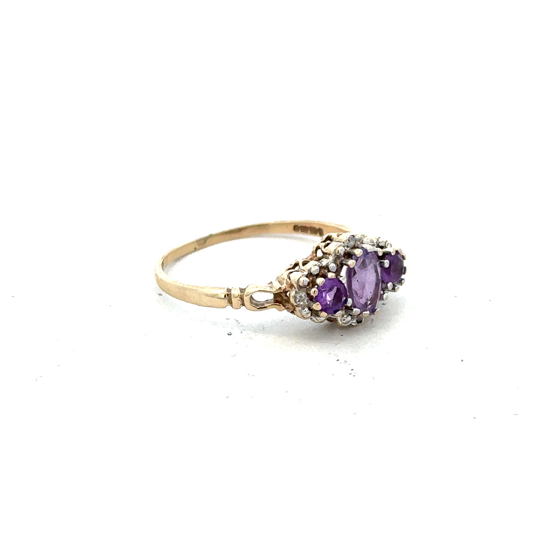 9ct yellow gold ring with diamond and amethyst gemstones, size Q, featuring a detailed design.