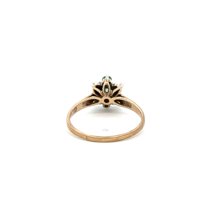 9ct yellow gold ring with diamond and emerald stones, size O, featuring a detailed design on a plain background.