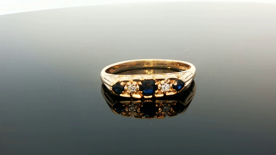 9ct yellow gold ring with diamonds and sapphires, stylish jewelry piece with intricate gemstone design.