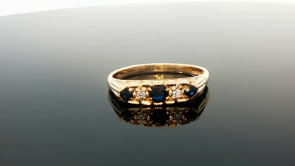 9ct yellow gold ring with diamonds and sapphires, stylish jewelry piece with intricate gemstone design.
