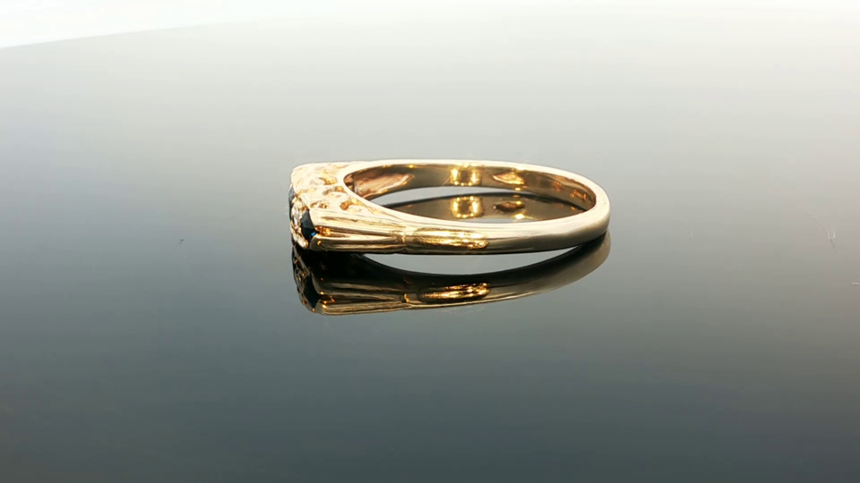 9ct yellow gold diamond and sapphire ring with a detailed band, featuring sparkling gemstones and elegant design.