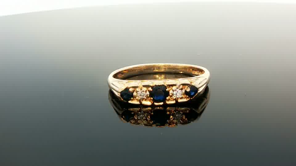 9ct yellow gold ring featuring diamonds and sapphires, with a detailed gemstone design, unbranded jewelry accessory.