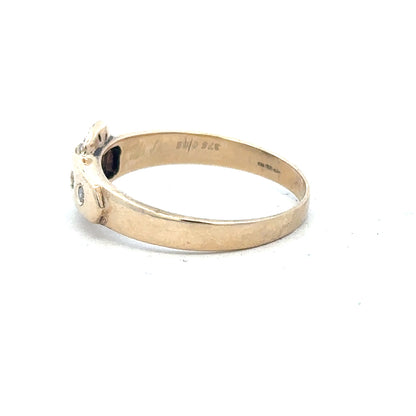9ct yellow gold diamond buckle ring in size R, showcasing a polished gold band with a decorative diamond accent.