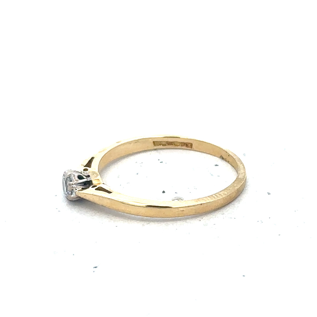9ct yellow gold diamond solitaire ring with a central round diamond and a sleek band, unbranded jewelry accessory.
