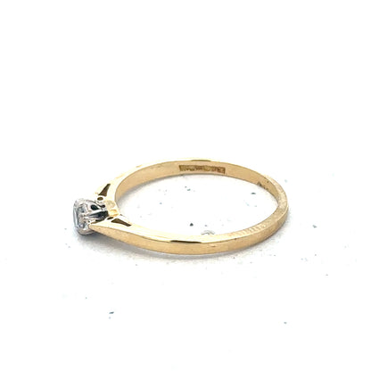 9ct yellow gold diamond solitaire ring with a central round diamond and a sleek band, unbranded jewelry accessory.