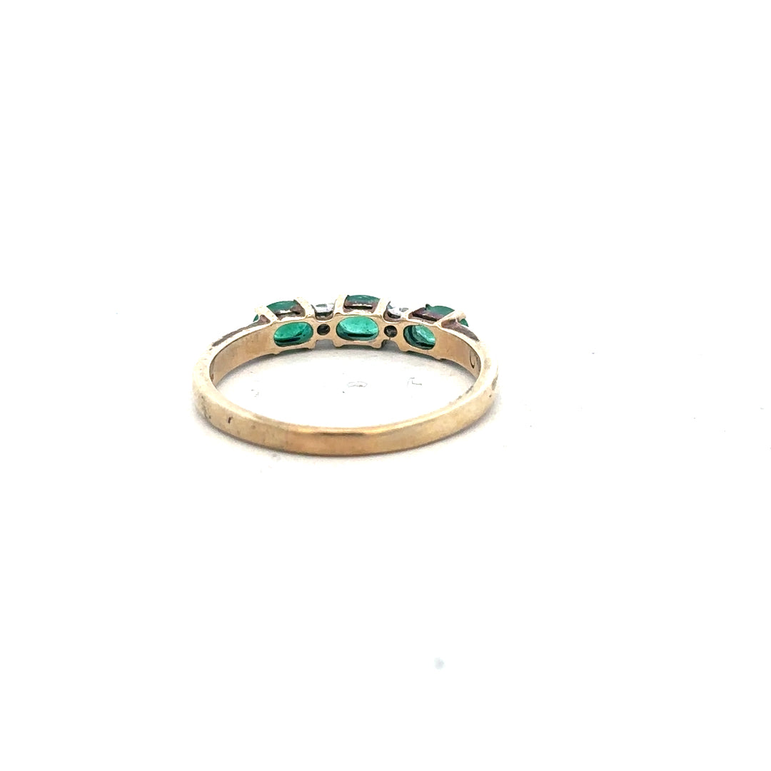 9ct yellow gold ring with emerald and diamond accents, size T, showcasing the detailed gemstone setting and elegant design.