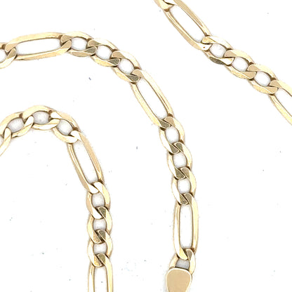9ct yellow gold figaro chain, unbranded, with 11g weight, displayed on a plain background showing the chain's links and shine.