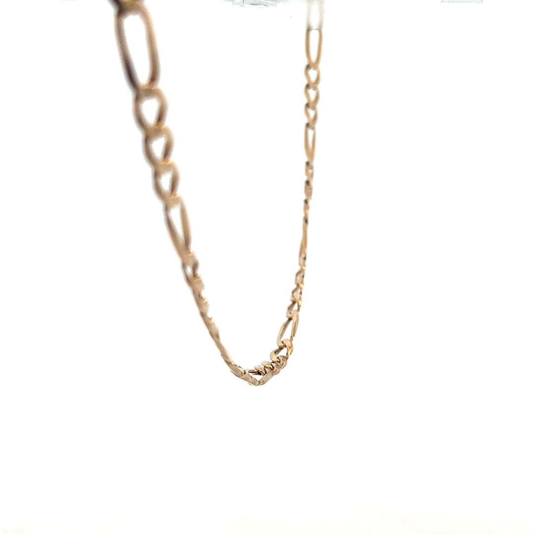 9ct yellow gold Figaro chain, unbranded, showcasing its detailed linked design and polished finish on a plain background.