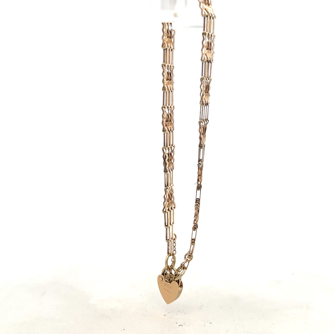 9ct yellow gold gate bracelet with a secure clasp, weighing 5.8g, showcasing a classic jewelry design.