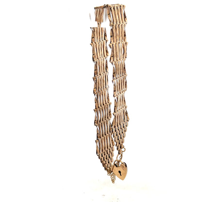 9ct yellow gold gate bracelet showcasing a classic linked chain design, unbranded, weighing 7.4 grams.