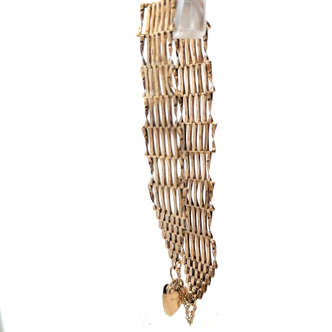 9ct yellow gold gate bracelet showcasing linked chain design, weight 7.4g, unbranded jewelry accessory.