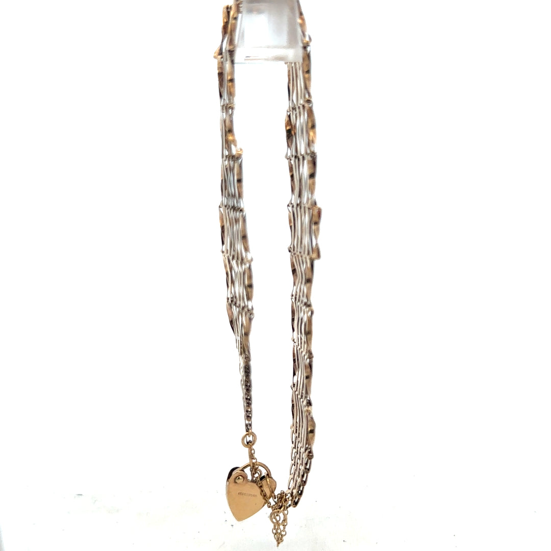 9ct yellow gold gate bracelet with a delicate chain design, weighing 7.4 grams, unbranded jewelry accessory.
