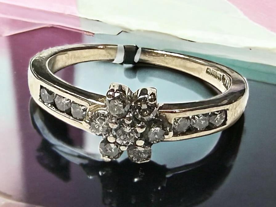 9ct yellow gold half-carat diamond ring in size M, featuring a sleek band and sparkling diamond accent.