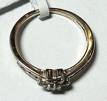 9ct yellow gold half-carat diamond ring in size M, featuring a sleek band and sparkling diamond accent.