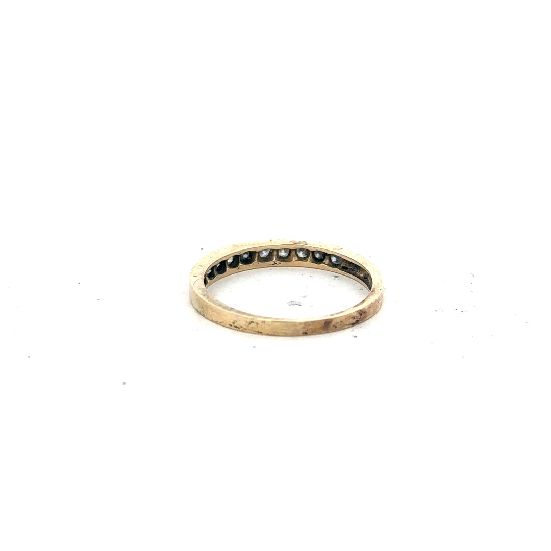 Yellow gold half eternity diamond ring, size N, showcasing sparkling diamonds around the band on a plain background.
