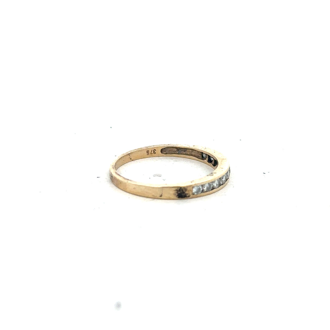 9ct yellow gold half eternity diamond ring in size N featuring a row of sparkling diamonds on a sleek band