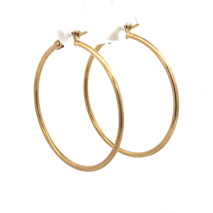 9ct yellow gold hoop earrings weighing 1.1g, unbranded, featuring classic round design with polished finish