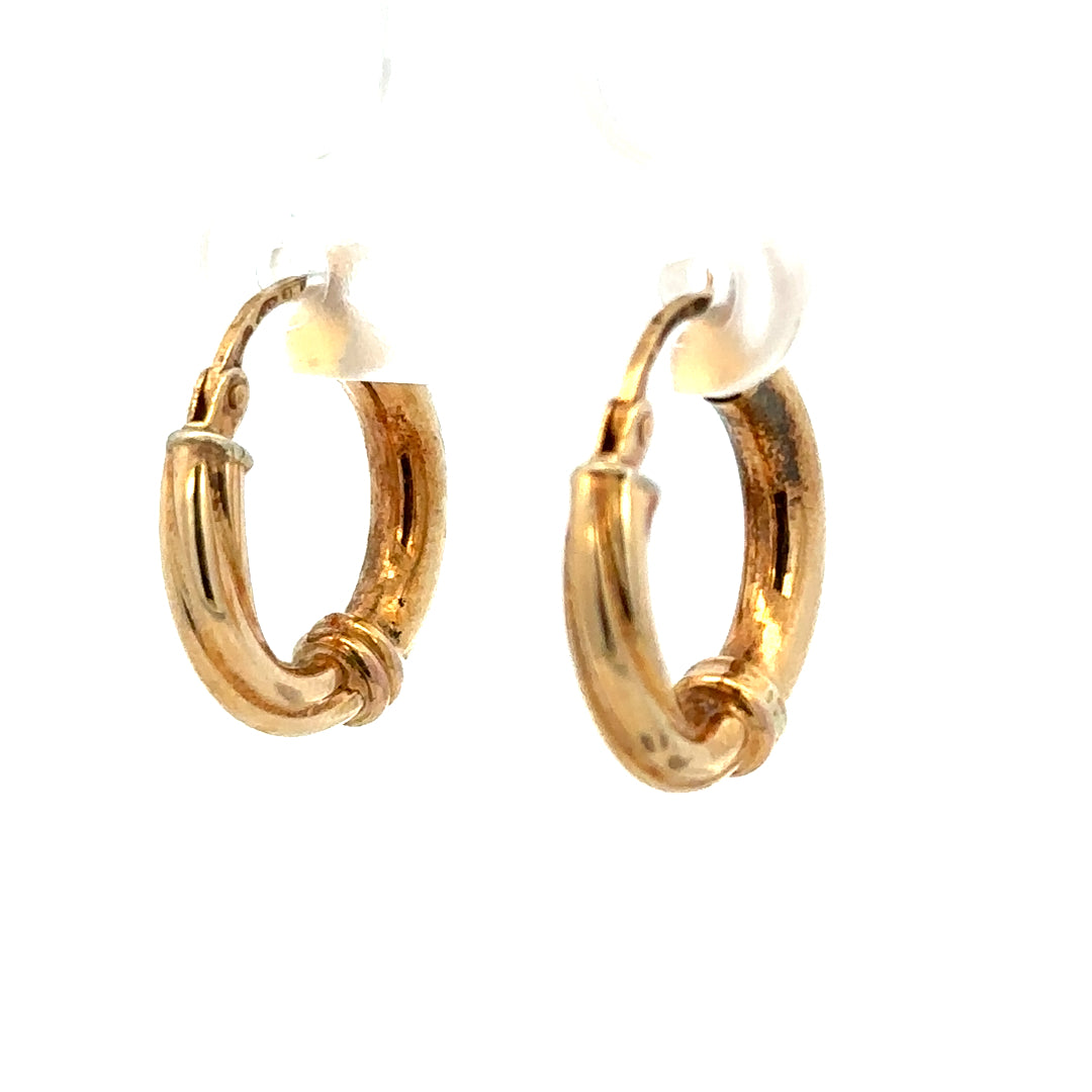 Smooth 9ct yellow gold hoop earrings weighing 1.5g, displayed on a neutral background, showcasing classic jewelry style.