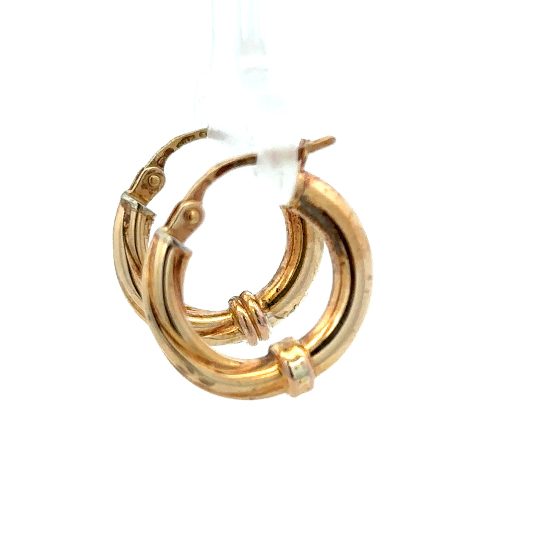 Pair of 9ct yellow gold hoop earrings weighing 1.5g, unbranded, with a smooth circular design for elegant everyday wear.