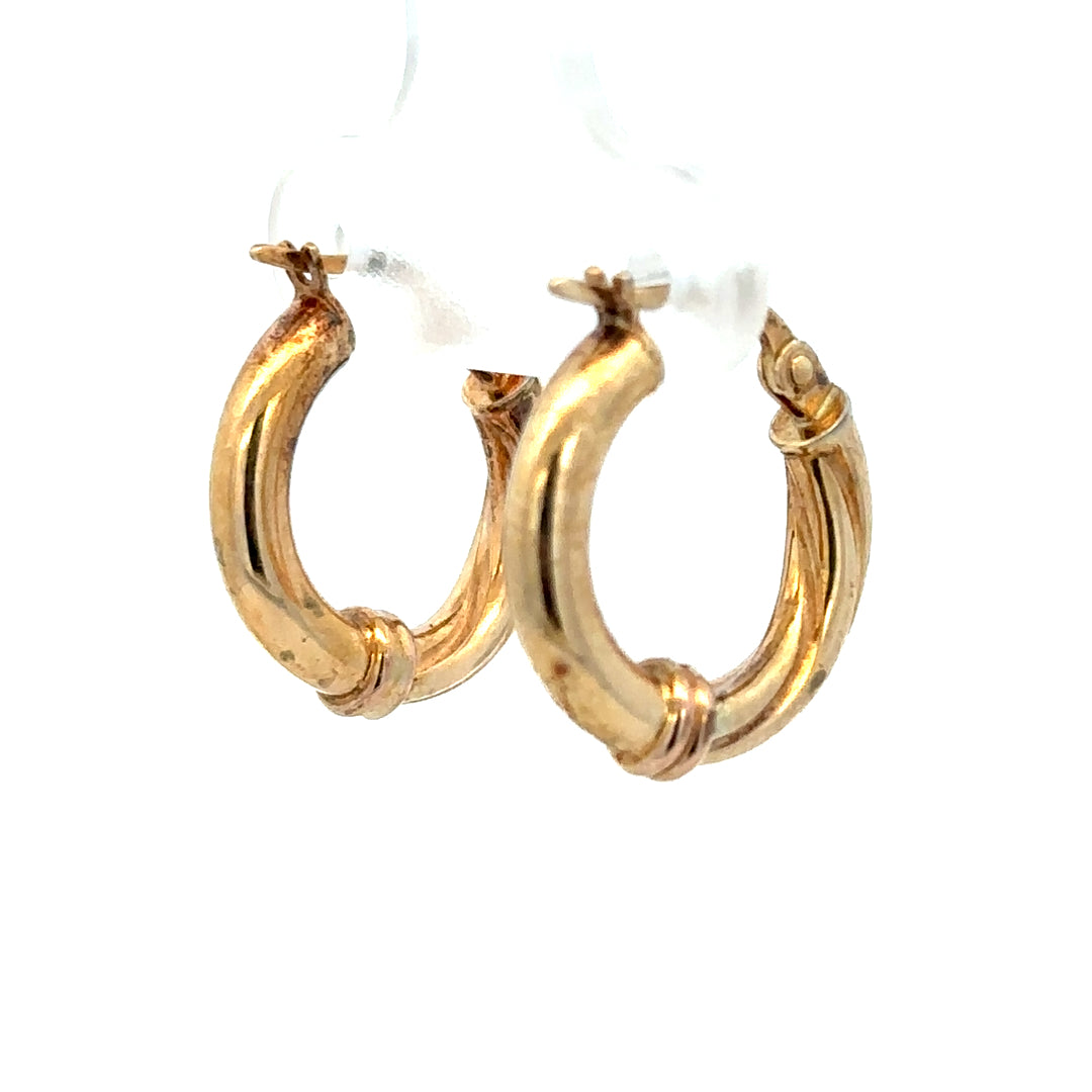 9ct yellow gold hoop earrings with a sleek design, weighing 1.5g, shown close-up on a neutral background.