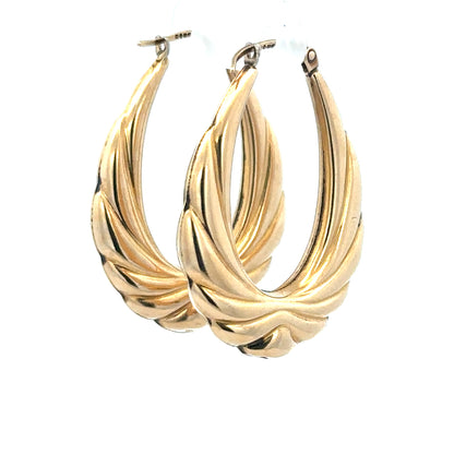 9ct yellow gold hoop earrings weighing 3.8g, unbranded, with a smooth circular design, shown on a plain background.
