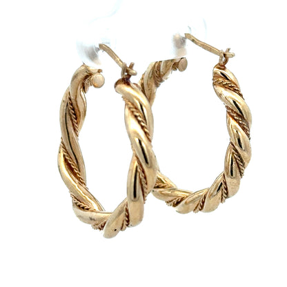 9ct yellow gold hoop earrings weighing 4.9g, shown in a close-up image highlighting their shiny, classic hoop design.