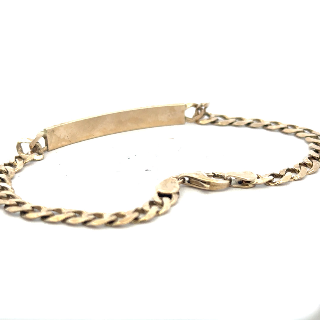 9ct yellow gold ID bracelet with polished finish, featuring a sleek rectangular plate and a secure clasp.