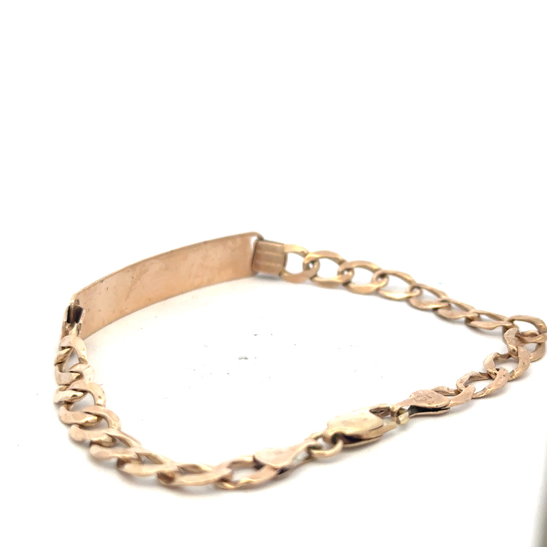 9ct yellow gold ID bracelet weighing 9.7g with a sleek, polished finish, featuring a secure clasp and smooth design.