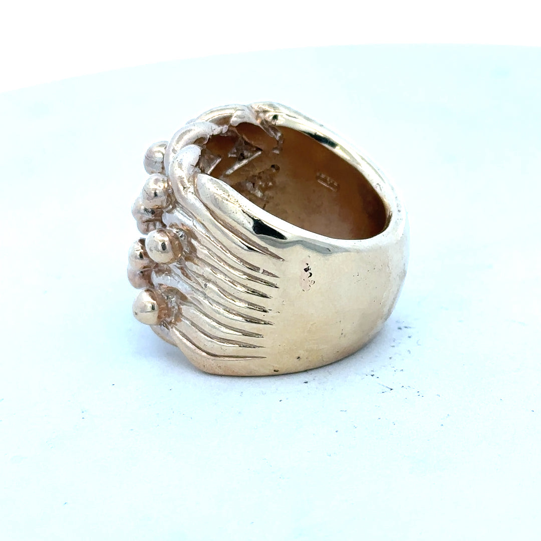9ct yellow gold keeper ring in size W, unbranded, with a smooth band and classic design, shown in a close-up image