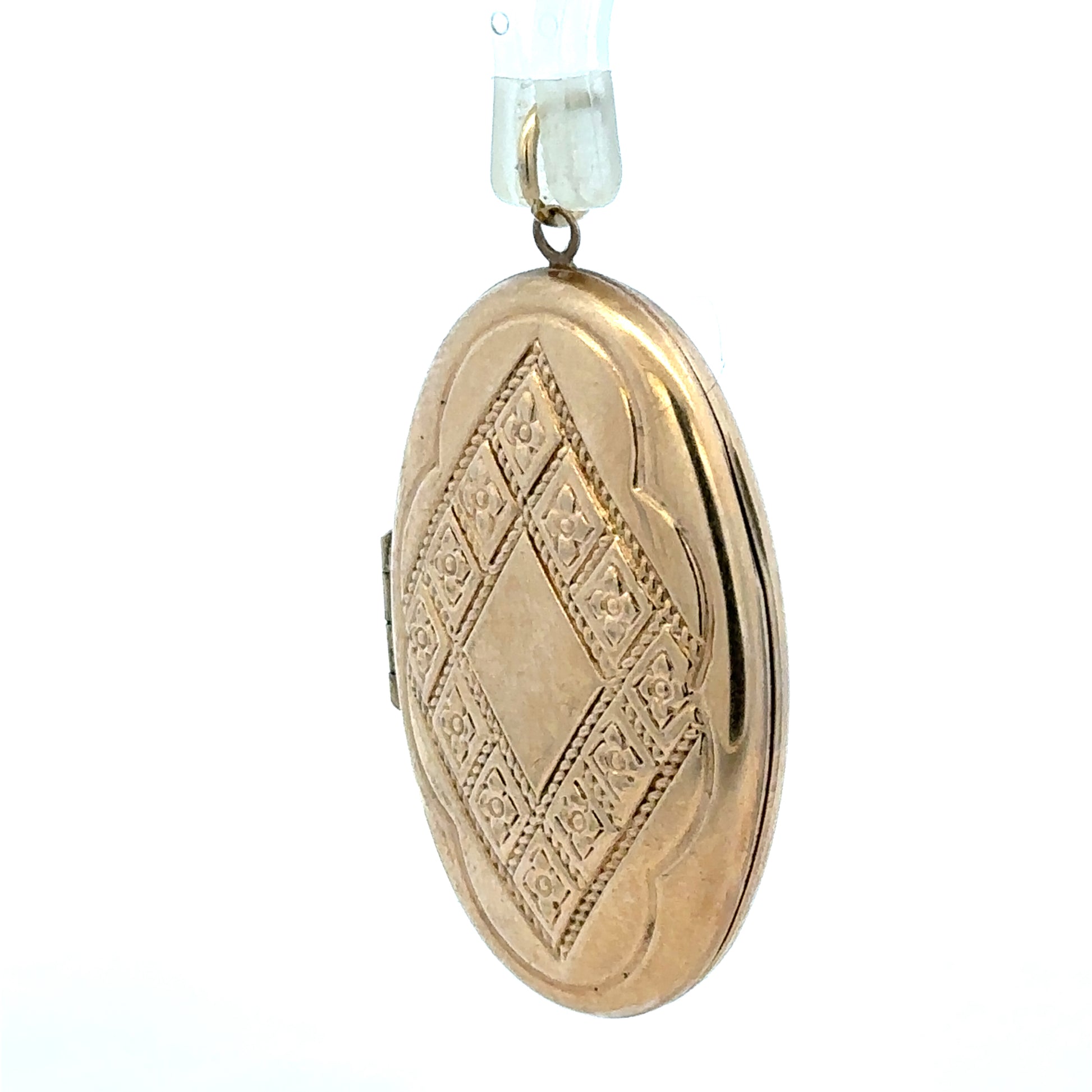 9ct yellow gold locket pendant, unbranded, weighing 5.8g, featuring a classic design with intricate detailing.