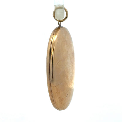 9ct yellow gold locket pendant showing intricate design and polished surface, weighing 5.8 grams, unbranded jewelry accessory.
