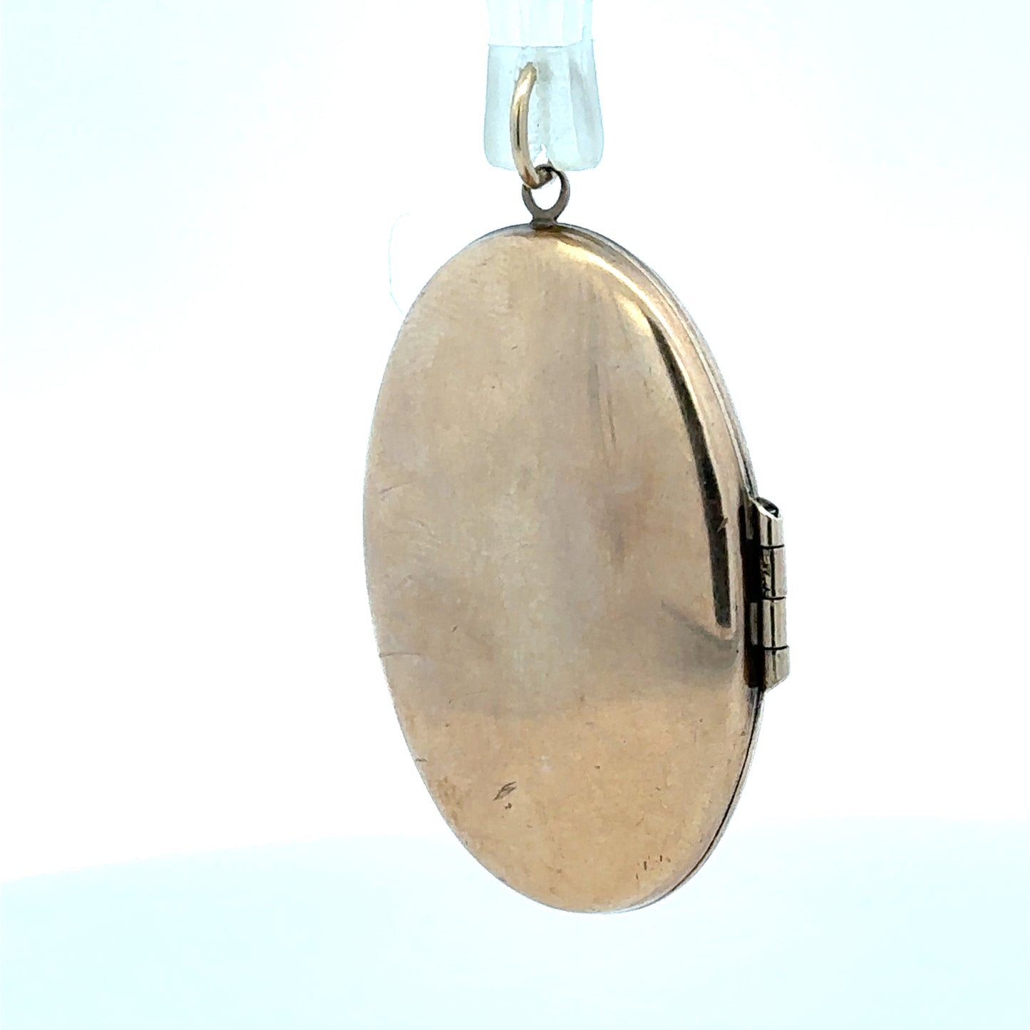 9ct yellow gold locket pendant, unbranded, weighing 5.8g, featuring a classic design, shown with intricate detailing and polished finish.