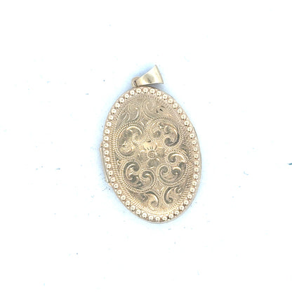 9ct yellow gold locket pendant with intricate design, weighs 6.3g, unbranded jewelry piece with a classic pendant style.