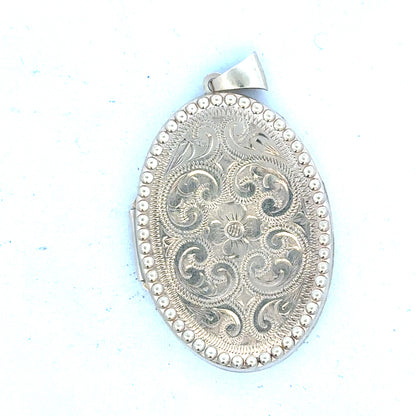 9ct yellow gold locket pendant, unbranded, weighing 6.3g, showcasing a polished, classic design with a secure bail attachment.