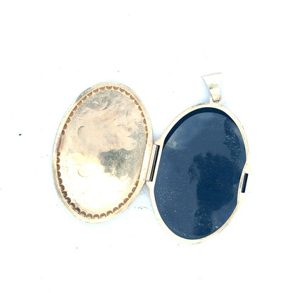 9ct yellow gold locket pendant, unbranded, weighing 6.3g, featuring a classic design with a smooth polished surface.